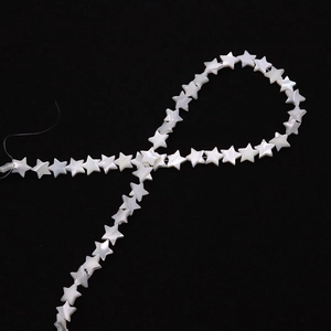 Macro detail of natural star-shaped mother of pearl beads with iridescent luster