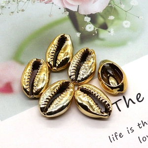 Set of six gold plated cowrie shell beads with polished metallic finish for jewelry making