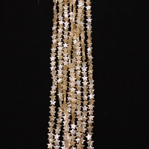 Detail of star-shaped natural white mother of pearl beads with iridescent luster finish