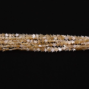 Macro shot of star-shaped natural white mother of pearl shell beads with pearl luster