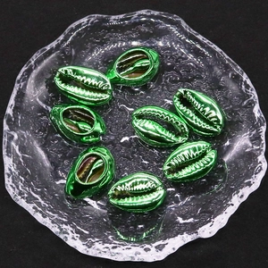 Details von metallisch grünen Muschelperlen für DIY-Schmuckherstellung in Glasbehälter