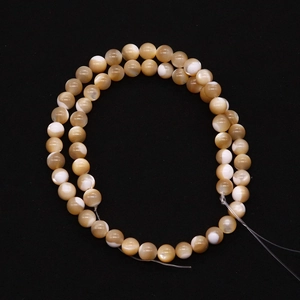 Polished natural shell round beads with cat eye effect arranged in dual circles