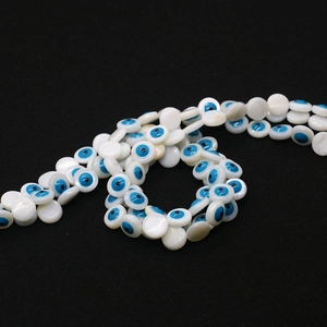 Macro detail of natural freshwater shell evil eye beads for DIY jewelry making