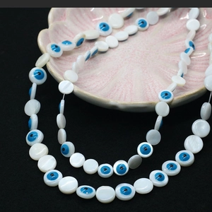 Macro shot of evil eye shell beads with white mother of pearl luster for DIY jewelry
