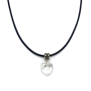 Detail of faceted clear heart-shaped crystal pendant on a black cord with silver clasp