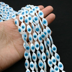 Macro shot of marquise shell beads with evil eye pattern for DIY jewelry design