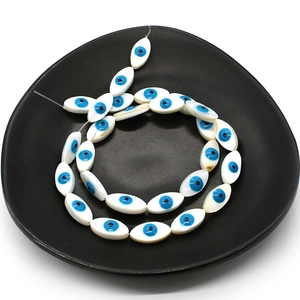 Natural marquise shell evil eye loose beads for DIY jewelry making on black tray