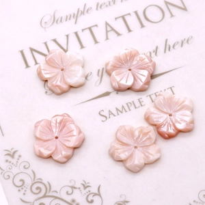 Macro detail of 20mm pink queen shell flower beads with a pearlescent luster finish