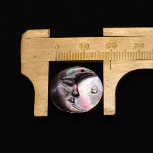 Macro view of shell pendant size measurement with 20mm celestial moon and star carving