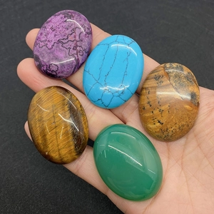 Five assorted 30x40mm oval natural stones including tiger eye and aventurine cabochons