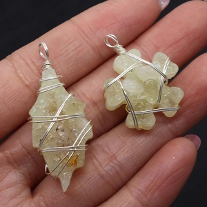 Set of two handcrafted wire wrapped natural yellow citrine pendants on a dark background