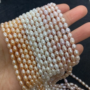 Gros plan de perles d'eau douce AAA en forme de riz, couleurs crème et lavande