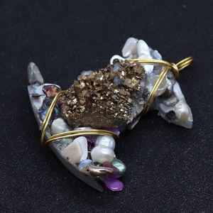 Macro view of crescent moon pendant with natural freshwater pearls and crystal clusters