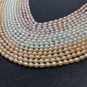 Vue macro de perles d'eau douce AAA de 5mm en forme de riz aux couleurs blanc, rose et orange