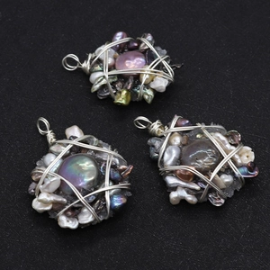Detailed view of handmade silver wire wrapped natural freshwater pearl resin pendants