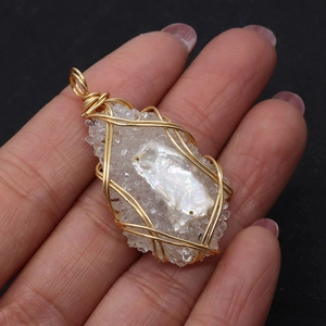 Detail of handmade wire-wrapped freshwater pearl and crystal resin cluster pendant