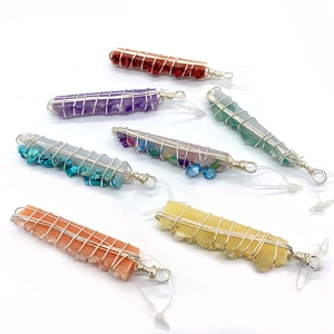 Set of seven handcrafted wire-wrapped natural crystal stone pendants in assorted colors