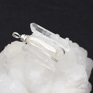 Detailed view of handmade silver wire wrapped natural crystal and baroque pearl pendant