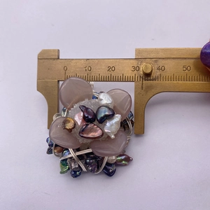 Detailansicht eines 35mm Blumenanhängers mit grauen Blütenblättern und Perlenwickel