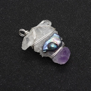 Détail d'un pendentif fait main en quartz blanc et perle baroque avec fil métallique