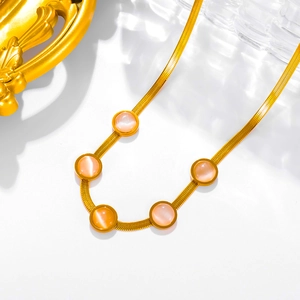 Detail of 18k gold plated snake chain necklace with five pink cat eye stones