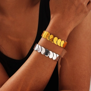 Polished titanium steel multilayer bangle featuring a geometric teardrop splicing design