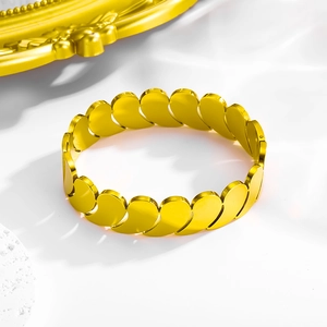 Detail of layered gold titanium steel bracelet featuring a unique water-drop splice design