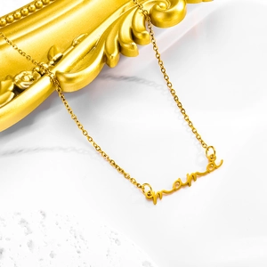 Gold minimalist mama letter pendant necklace on a decorative textured background