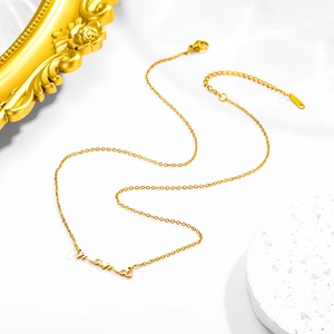 Macro detail of gold mama pendant necklace with adjustable chain and lobster clasp