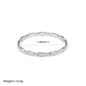 Macro shot of silver diamond-encrusted steel bangle with 60mm diameter and 16.5g weight
