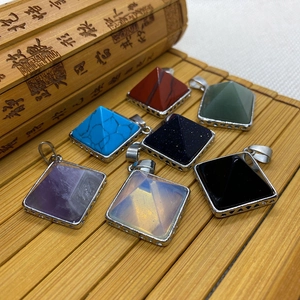 Detailed view of seven pyramidal gemstone pendants with silver hollow triangle metal caps