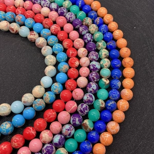 Macro shot of colorful sea sediment jasper beads in various vibrant textures for DIY jewelry