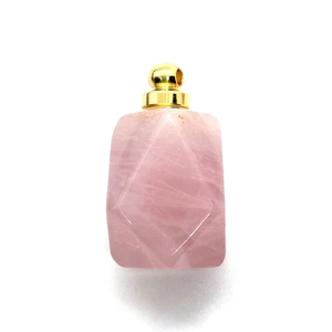 Natural rose quartz perfume bottle pendant with gold metal cap and carved geometric pattern