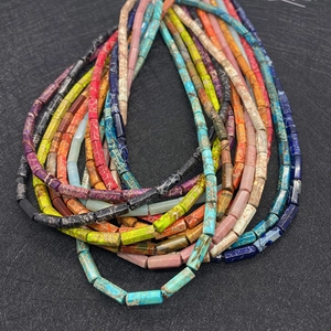 Macro detail of colorful cylindrical emperor stone beads with natural mineral texture