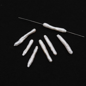 Macro detail of natural irregular baroque stick pearls with silver needle through hole
