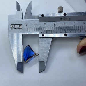 Detail showing natural blue stone fan pendant with gold trim measured by caliper