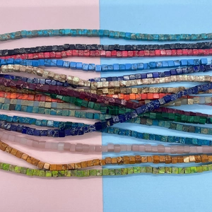 Macro detail of 3mm colorful Imperial Jasper cube beads for DIY necklace jewelry making