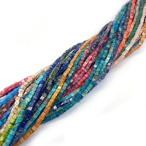 Macro shot of 3mm natural cubic stone beads in turquoise, lapis, and tiger eye textures