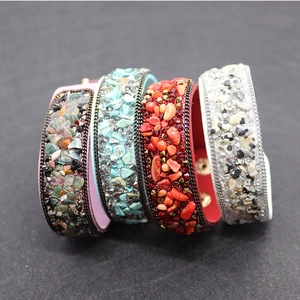 Detailed close-up of Bohemian leather bracelets with colorful stone chips and metal chain edges