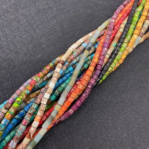 Detailed view of colorful cylindrical Imperial Jasper beads with unique natural textures