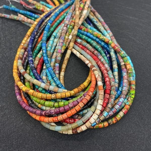 Macro detail of colorful cylindrical natural stone beads with unique marbled textures
