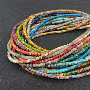 Macro shot of colorful cylindrical stone beads with natural texture and diverse colors