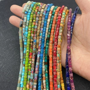 Colorful cylindrical natural stone beads showing turquoise texture and artistic patterns