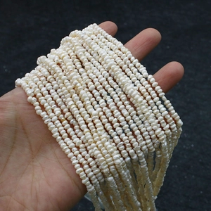 Macro detail of 2-3mm high-luster natural freshwater pearls strands for DIY jewelry