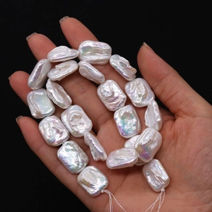 Detailed close-up of natural white freshwater baroque rectangle pearls showing colorful luster