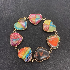 Detail of heart-shaped natural stone connectors with colorful imperial jasper patterns