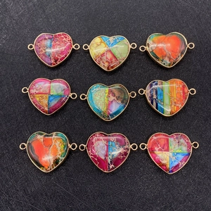 Macro display of nine heart-shaped natural stone pendants with gold-plated metal edges