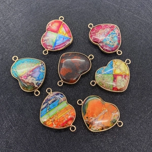 Macro shot of colorful heart-shaped stone connectors with golden metal edges for jewelry DIY