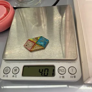 Detailed view of a 4.01g hexagonal turquoise stone pendant on a digital scale