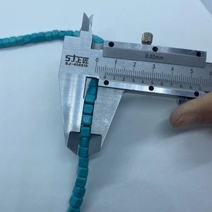 Detailed measurement of turquoise square cube beads using a vernier caliper for DIY jewelry